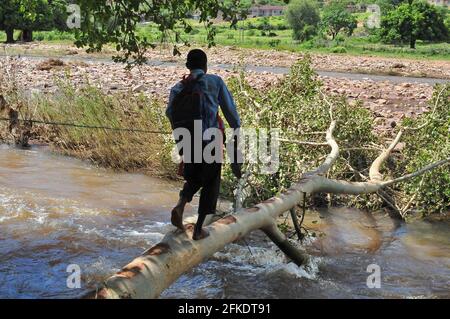 Rural village residents in Sane in Limpopo still cross rivers to ferry children to school due to infrastructure shortage issues Stock Photo