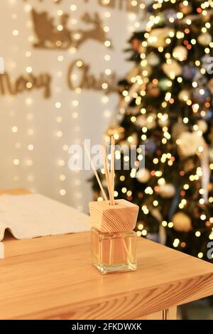 Aromatherapy reed diffuser air freshener on relaxed christmas background Stock Photo