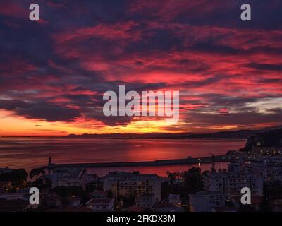 Fiery clouds, looking west, just after sunset over the Mediterranean Sea of the French Riviera. Nice, Alpes-Maritimes, France. Stock Photo