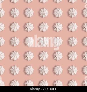 Creative seamless pattern with meringue cookies on a ligth pink background Stock Photo