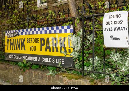 Signs outside a primary school in London warning drivers of he danger of idling their cars on children’s health. Stock Photo