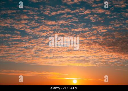 Sunset Cloudy Sky With Clouds. Sunset Sky Natural Background. Dramatic Sky. Sunset In Yellow, Orange, Pink Colors Stock Photo