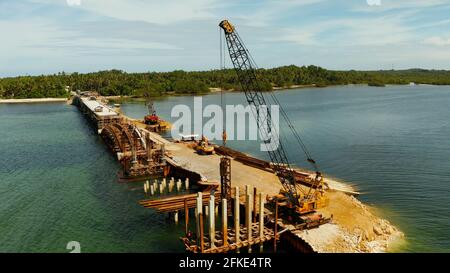 Heavy pile driving machine installing concrete foundation piles at an ...