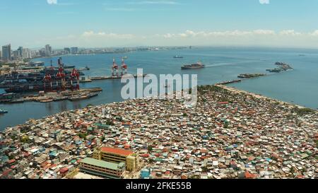 Shacks in the slums of Manila in a poor district and skyscrapers of a ...