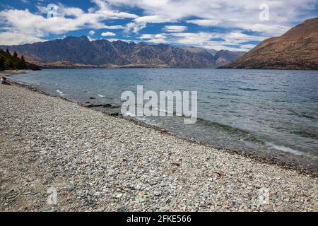 QUEENSTOWN, OTAGO, NEW ZEALAND - FEBRUARY 17 : View of the Remarkables mountain range in New Zealand on February 17, 2012. Two unidentified people Stock Photo