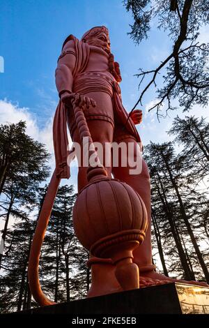 lord hanuman at jakhu mandir.33 m high statue located near the monkey temple with beautiful natural background. Stock Photo