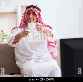 The arab businessman watching tv at home Stock Photo