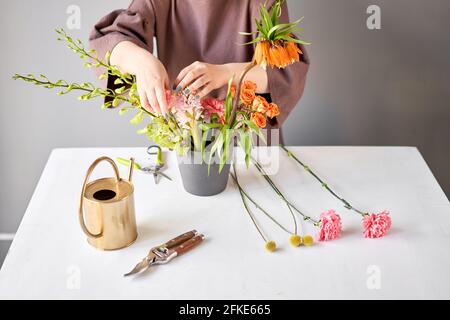 Step by step installation of flowers in a vase. Flowers bunch, set for home. Fresh cut flowers for decoration home. European floral shop. Delivery Stock Photo
