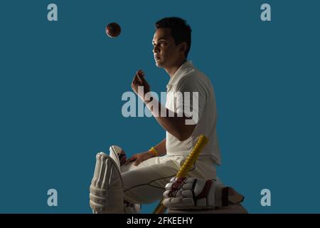 A batsman, Cricketer sitting in dressing room Stock Photo