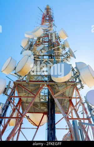 Low angle view of a communication tower with parabolic antennas Stock Photo