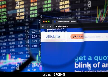 Allstate company logo on a website with blurry stock market developments in the background, seen on a computer screen through a magnifying glass Stock Photo