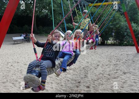 kids swinging on a swing Stock Photo