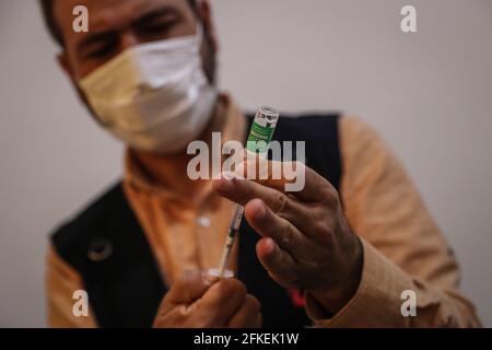 Idlib, Syria. 01st May, 2021. A member of the Syria Vaccine Team prepares a dose of COVID-19 vaccine during the first phase of the vaccination campaign, aimed at medical and humanitarian workers, at Ibn Sina Hospital in Idlib. Credit: Anas Alkharboutli/dpa/Alamy Live News Stock Photo