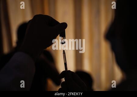 Idlib, Syria. 01st May, 2021. A member of the Syria Vaccine Team prepares a dose of COVID-19 vaccine during the first phase of the vaccination campaign, aimed at medical and humanitarian workers, at Ibn Sina Hospital in Idlib. Credit: Anas Alkharboutli/dpa/Alamy Live News Stock Photo