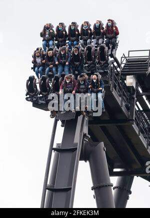 Soltau Germany. 01st May 2021. Visitors ride a roller coaster at