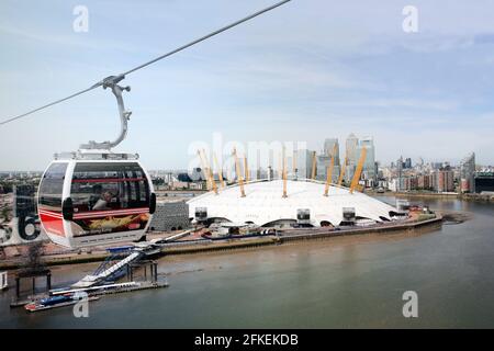 LONDON - MAY 26: Gondolas of the Emirates Air Line cable car, opened June 2012, run by TFL, links the Greenwich Peninsula with Royal Dock, 1km, across Stock Photo