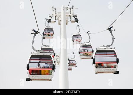 LONDON - MAY 26: Gondolas of the Emirates Air Line cable car, opened June 2012, run by TFL, links the Greenwich Peninsula with Royal Dock, 1km, across Stock Photo