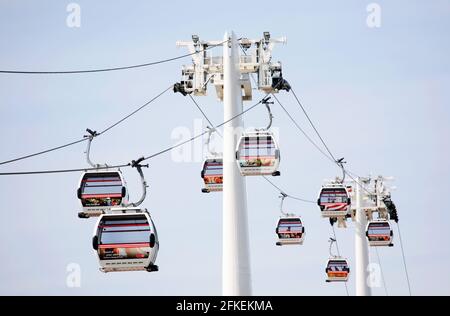 LONDON - MAY 26: Gondolas of the Emirates Air Line cable car, opened June 2012, run by TFL, links the Greenwich Peninsula with Royal Dock, 1km, across Stock Photo