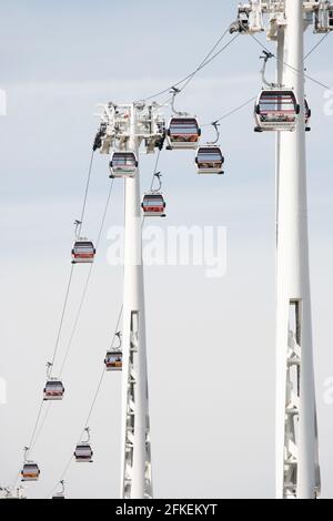 LONDON - MAY 26: Gondolas of the Emirates Air Line cable car, opened June 2012, run by TFL, links the Greenwich Peninsula with Royal Dock, 1km, across Stock Photo