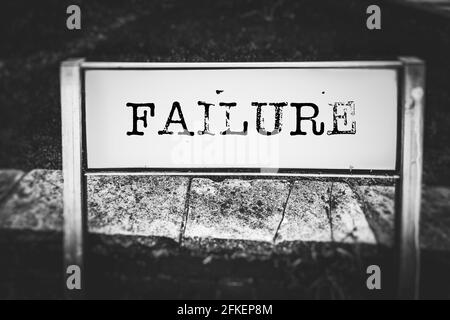 Failure displayed on a street sign in black and white Stock Photo