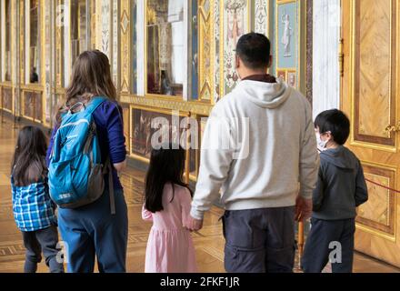 Family, man and woman with three children at the exhibition in the Hermitage museum, back view, St. Petersburg, Russia Stock Photo