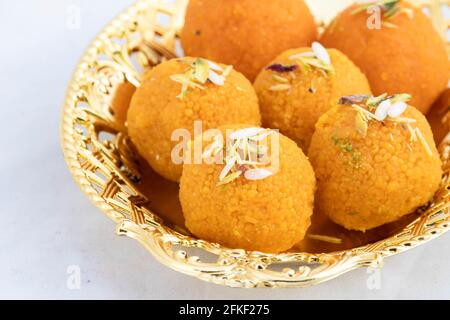 Indian Mithai Motichur Laddu Also Called Motichoor Ladoo Made Of Bengal Gram Flour Besan In Golden Tray. Meetha Laddoo Is Served On Festivals Like Hol Stock Photo