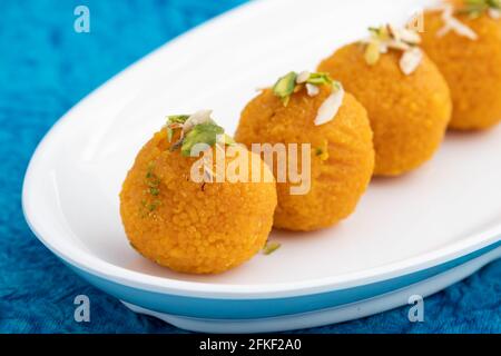 Widely Popular Motichur Laddu Also Called Motichoor Ladoo Is Sweet Mithai Decorated In White Tray. Meetha Laddoo Deep Fried In Desi Ghee On Bright Tur Stock Photo