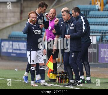 Millwall manager Gary Rowett (right) speaks to Millwall's Ryan Woods (left) during the Sky Bet Championship match at The Den, London. Issue date: Saturday May 1, 2021. Stock Photo