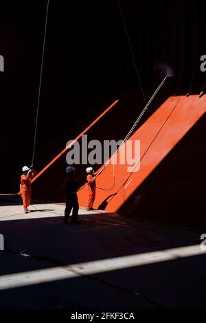crew preparing cargo hold before loading in the hold of big bulk carrier vessel Stock Photo