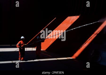 crew preparing cargo hold before loading in the hold of big bulk carrier vessel Stock Photo