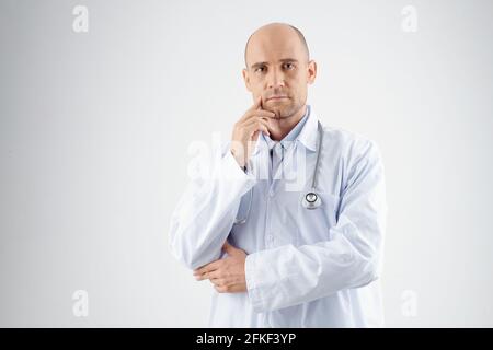 Portrait of confident physician in labcoat thinking and looking at camera, healthcare and medicine concept Stock Photo