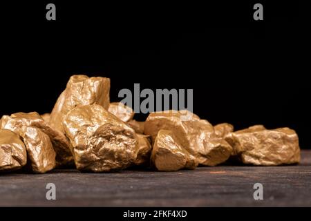 Gold nuggets on a black background, closeup. Stock Photo