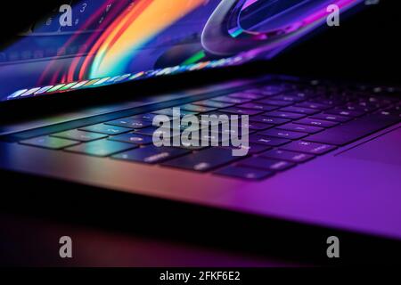 SIde Shot of a Glowing Laptop Stock Photo