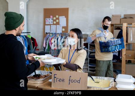 A group of volunteers giving free food to people in need Stock Photo
