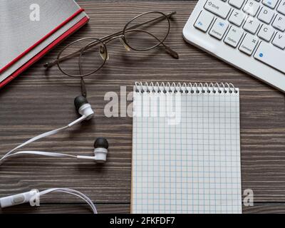 High angle view of computer keyboard and notepad on table Stock Photo