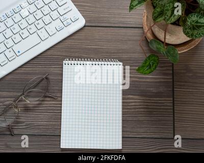 High angle view of computer keyboard and notepad on table Stock Photo