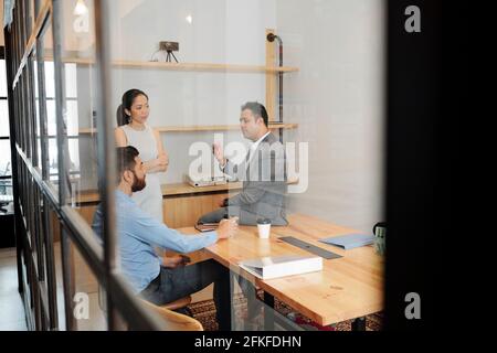 Managers of department having daily meeting, they are discussing fresh ideas for business development and seeking new opportunities to stay afloat amid COVID-19 Stock Photo