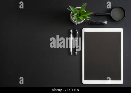 Office black workspace with office supplies and copy space on black background, flat lay Stock Photo