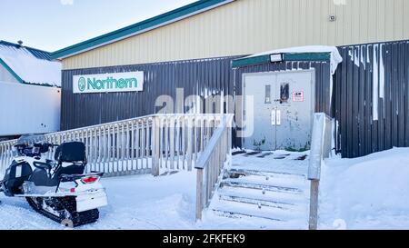 Ulukhaktok Northwest territories Canada February 11 2021: Northern foods grocery store with a snowmobile out front Stock Photo