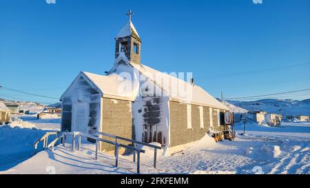 Ulukhaktok Northwest territories Canada February 11 2021: Old snow covered church in small northern Canadian town Stock Photo