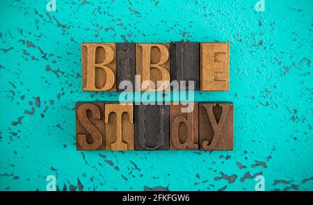 Bible Study Spelled in Wooden Type Set Block Letters on a Turquoise Background Stock Photo