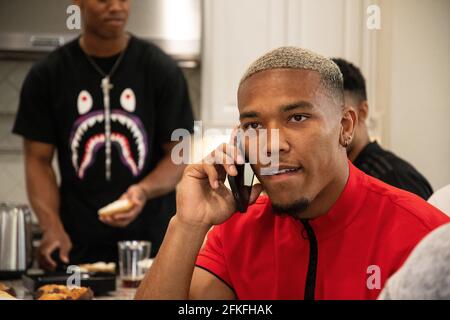 Lake Forest, USA. 01st May, 2021. German-American football player Amon-Ra St. Brown talks on the phone with Detroit Lions officials. The team selected the 21-year-old 112th overall in the draft. Credit: Maximilian Haupt/dpa/Alamy Live News Stock Photo