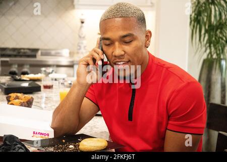 Lake Forest, USA. 01st May, 2021. German-American football player Amon-Ra St. Brown talks on the phone with Detroit Lions officials. The team selected the 21-year-old 112th overall in the draft. Credit: Maximilian Haupt/dpa/Alamy Live News Stock Photo