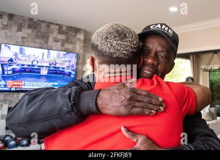 Lake Forest, USA. 01st May, 2021. German-American football player Amon-Ra St. Brown hugs his father, John Brown, after being selected in the NFL draft by the Detroit Lions. Credit: Maximilian Haupt/dpa/Alamy Live News Stock Photo