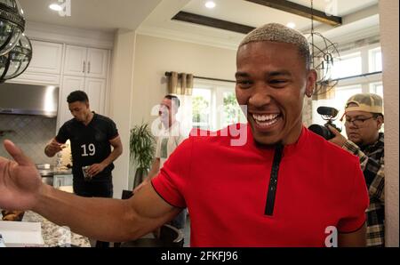 Lake Forest, USA. 01st May, 2021. German-American football player Amon-Ra St. Brown is happy after being selected in the NFL draft by the Detroit Lions. In the background is his brother Equanimeous St. Brown (l), who already plays for the Green Bay Packers. Credit: Maximilian Haupt/dpa/Alamy Live News Stock Photo