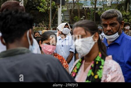Mumbai, India. 01st May, 2021. People wearing face mask wait in a queue to enter Bandra Kurla Complex (BKC) vaccination center in Mumbai. Vaccination drive for 18-44 years age group started on 1st May 2021. only those people who were eligible for the vaccine received confirmation about their registration on the phone. Credit: SOPA Images Limited/Alamy Live News Stock Photo