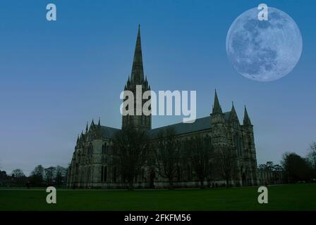 The silhouette of Salisbury Cathedral under the light of full moon in Wiltshire, UK Stock Photo