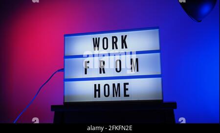 Work from home light box in studio. WFH Text on lightbox. Represent work from home for social distancing concept during coronavirus pandemic. WFH mess Stock Photo