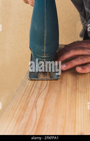 Sawing wood by hand worker Stock Photo