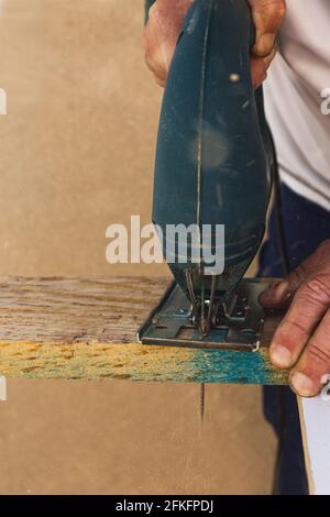 Sawing wood by hand worker Stock Photo